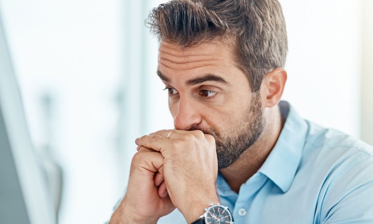 man-eyes-wide-gaze-distant-hands-clasped-768